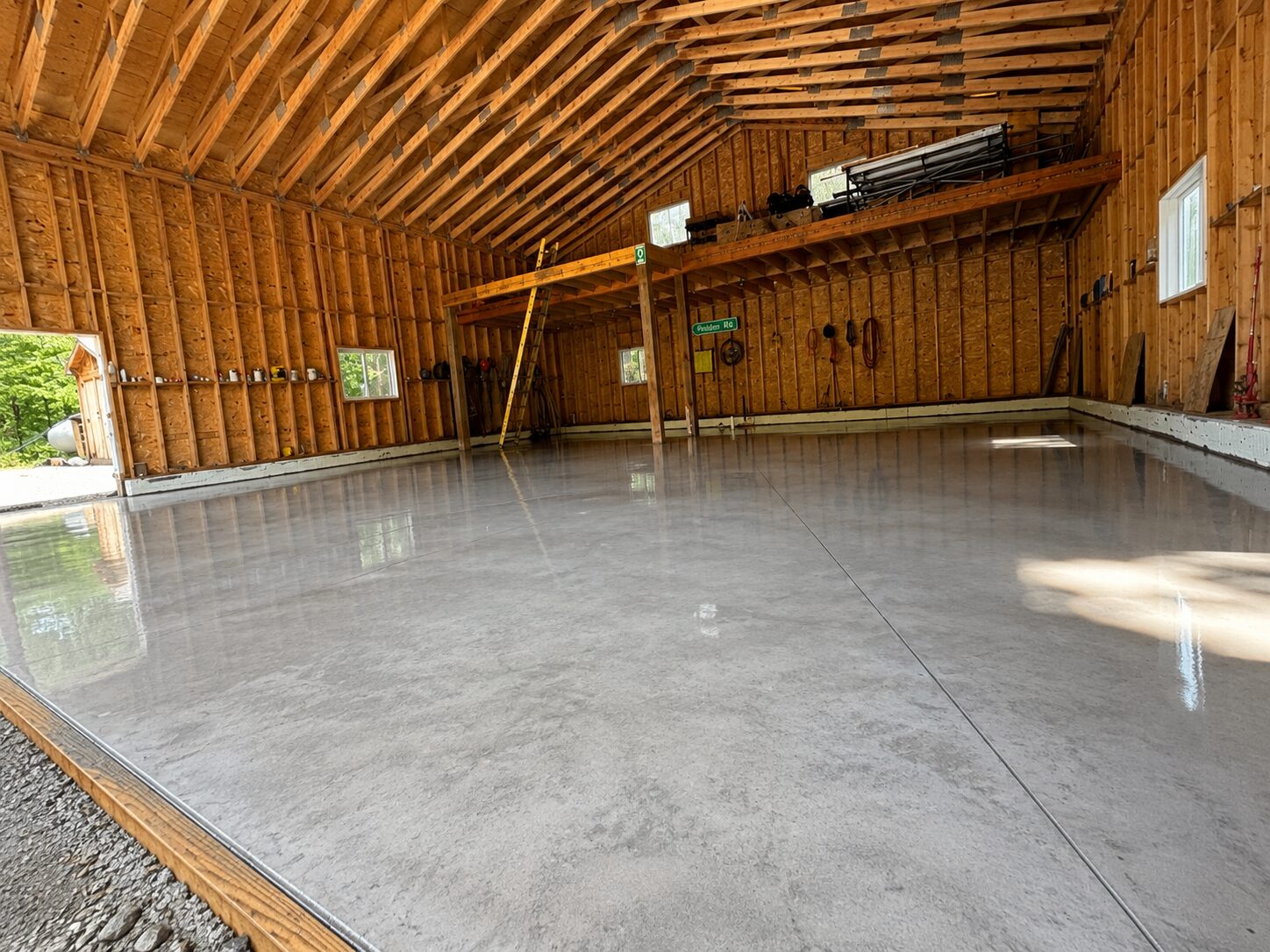 Wide view of a polished concrete garage floor with a glossy finish